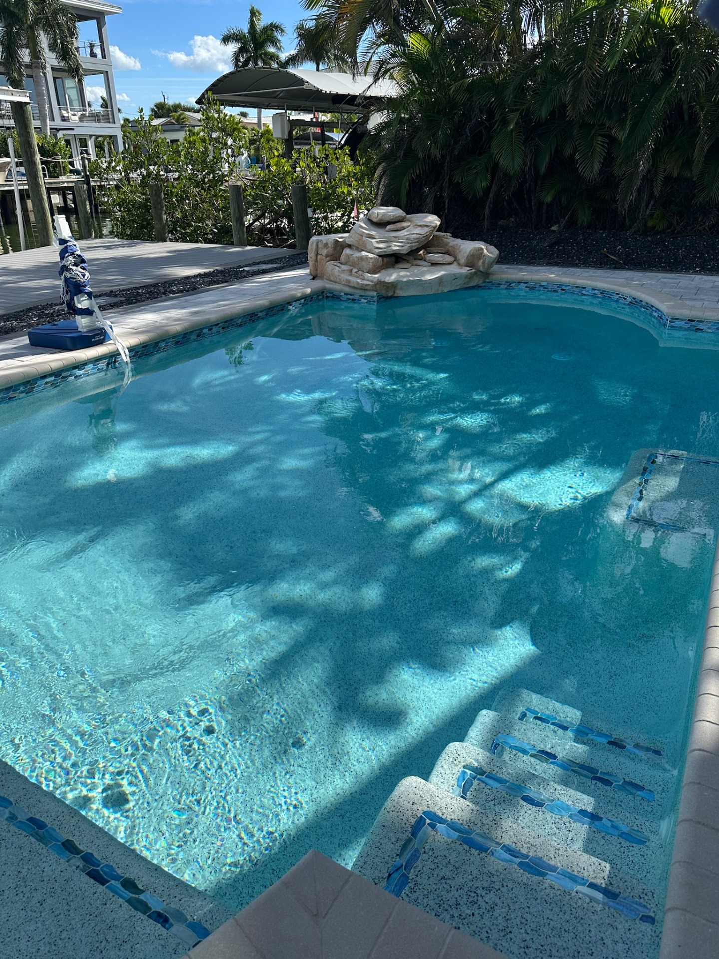 Canal-front pool with tiled entry steps